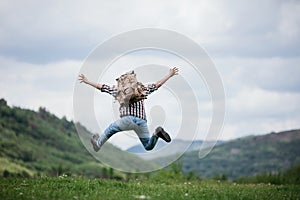 Happy Man traveler jumping with backpack in mountains active summer vacations, travel concept
