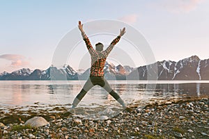 Happy man traveler jumping outdoor travel lifestyle