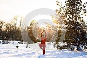 Happy man, traveler practicing yoga in the winter forest