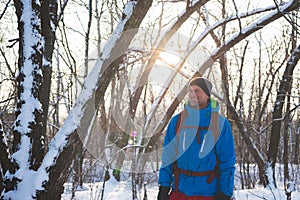 Happy man, traveler walking in the winter forest