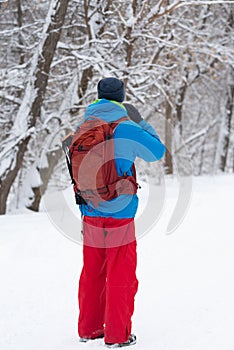 Happy man, traveler walking in the winter forest