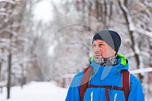 Happy man, traveler walking in the winter forest