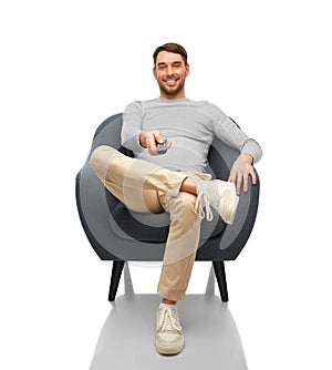 happy man with tv remote control sitting in chair