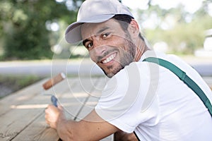 happy man uses roller on bench