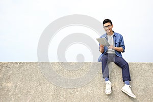 Happy man using digital tablet