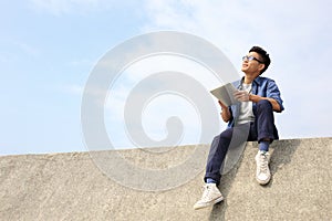 Happy man using digital tablet