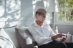 Happy man using digital tablet