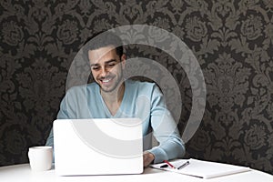 Happy man using a laptop