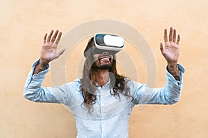 Happy man using virtual reality headset outdoor - Trendy guy having fun with innovated vr googles technology
