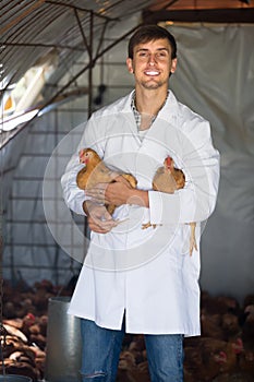 Happy man veterinarian in white coat