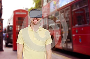 Happy man in virtual reality headset or 3d glasses