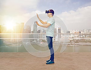 Happy man in virtual reality headset or 3d glasses