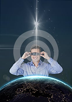 Happy man in VR headset looking to 3D planet against blue background with stars and flares