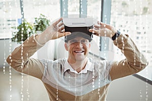 Happy man with VR headset standing behind interfaces