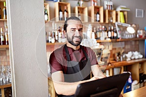 Happy man or waiter at bar cashbox