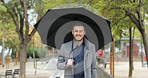 Happy man walking under the rain in winter