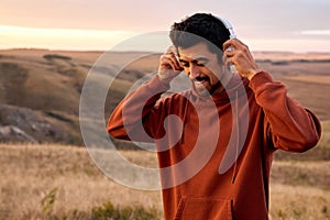 Happy Man Wearing Headphones Before Training In Mountains, Motivated, Smiling