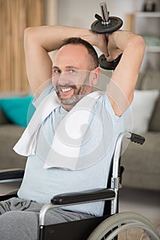 happy man in wheelchair doing sports