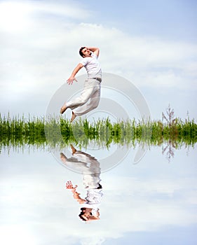Happy man in white clothes is jumping