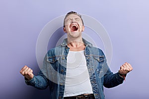 Happy man with wide open mouth, closed eyes expressing his gladness, happiness