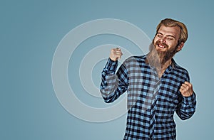 Happy man winning, fists pumped celebrating success