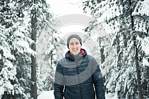 Happy man in winter season with tree on the back