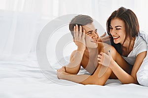 Happy man and woman in bed