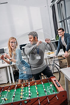 happy man and woman celebrating victory in table soccer