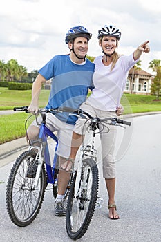 Happy Man & Woman Couple Riding Bikes