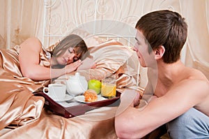 Happy man and woman having luxury hotel breakfast