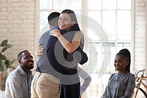 Happy man and woman hug showing support at therapy session