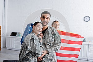 Happy man and woman in military