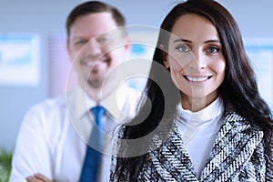 Happy man and woman office workers smiling at work