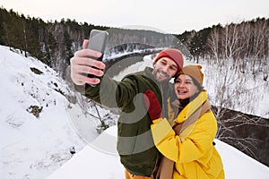 Happy Man And Woman Taking Selfie On Winter Day