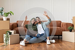 Happy man and woman using laptop after relocation