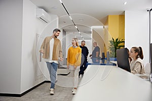 Happy man and woman with walking through modern clinic hall