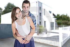 Happy man woman young couple from behind front of new modern architectural design style home house