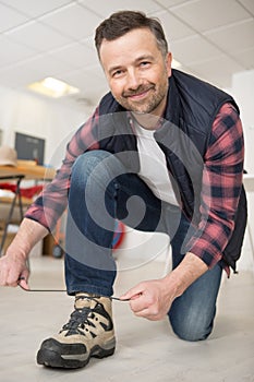 happy man worker doing up laces