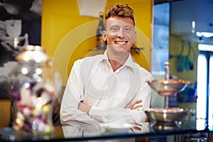 Happy man working as barman smiling in bar photo