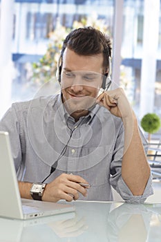 Happy man working at callcenter photo