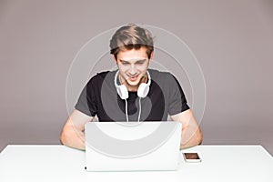 Happy man working in front of laptop on office table