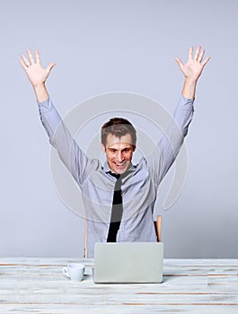 Happy man working on laptop in the office