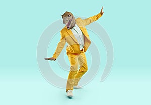 Happy man in yellow suit and funny dinosaur mask balancing on pretend skateboard