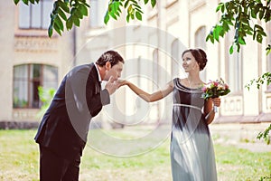 Happy marriage concept. Groom kissing brides hand