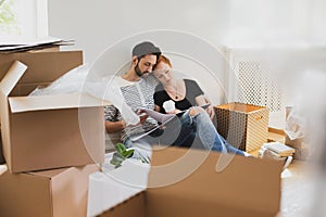 Happy marriage packing stuff into carton boxes while moving-out