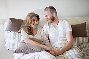 Happy married couple being romantic and sensual in bed