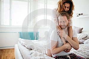 Happy married couple being romantic and sensual in bed