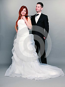 Happy married couple bride groom on gray background