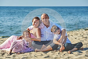 Happy married couple with children on their wedding anniversary day in their wedding dresses .