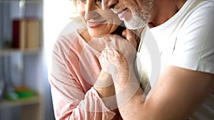 Happy married couple holding hands, old age togetherness, love and understanding photo